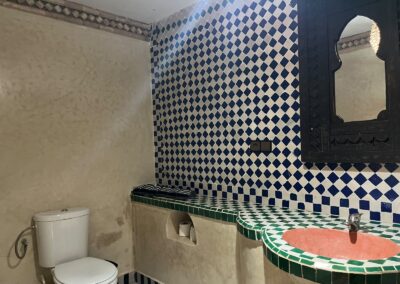 Bathroom with patterned tiles and washbasin
