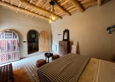 Bedroom with traditional textiles and wooden ceiling