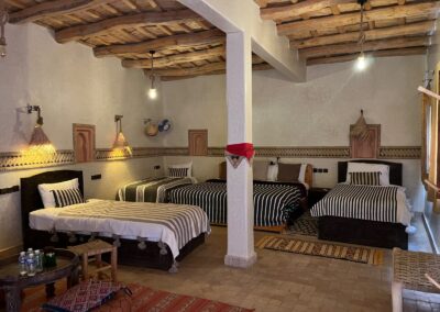 Bedroom with several beds and a wooden ceiling