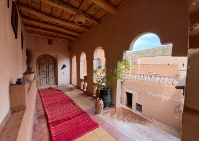 Arched corridor with a red carpet at Dar Essalama