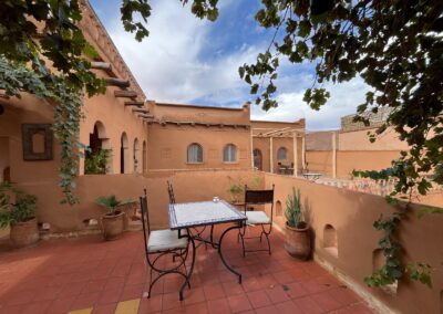 Open-air terrace with tables and views of the guest house